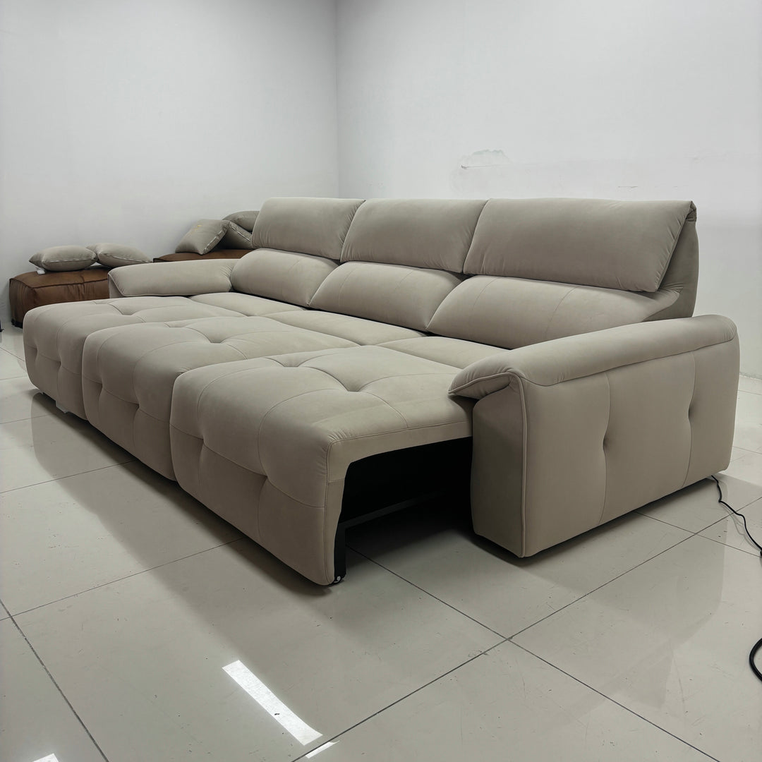 Modern beige sectional sofa with tufted upholstery in a minimalist living room