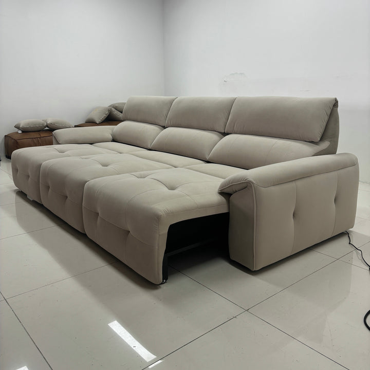 Modern beige sectional sofa with tufted upholstery in a minimalist living room