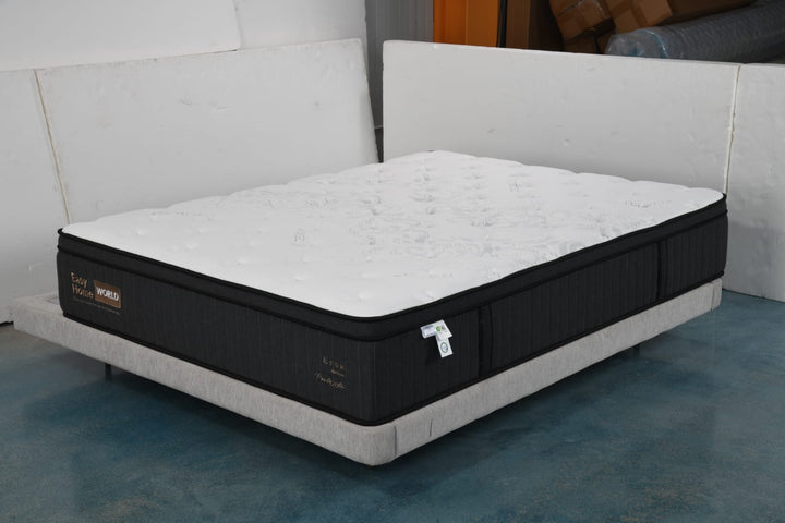 Modern queen size mattress with white top and black sides on a low-profile bed base