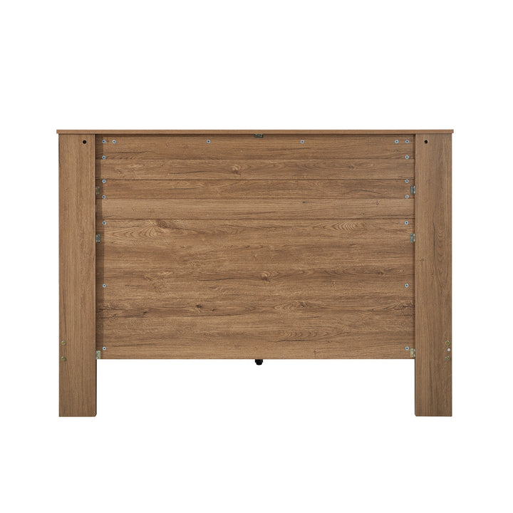 Wooden bed headboard with natural finish and visible wood grain texture