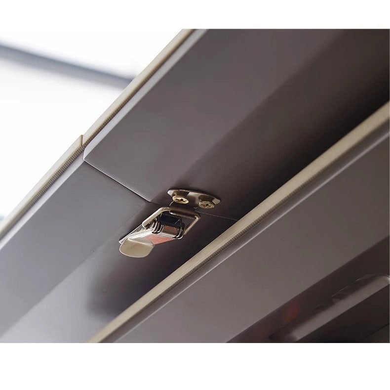 Close-up of metal latch hardware on modern furniture surface