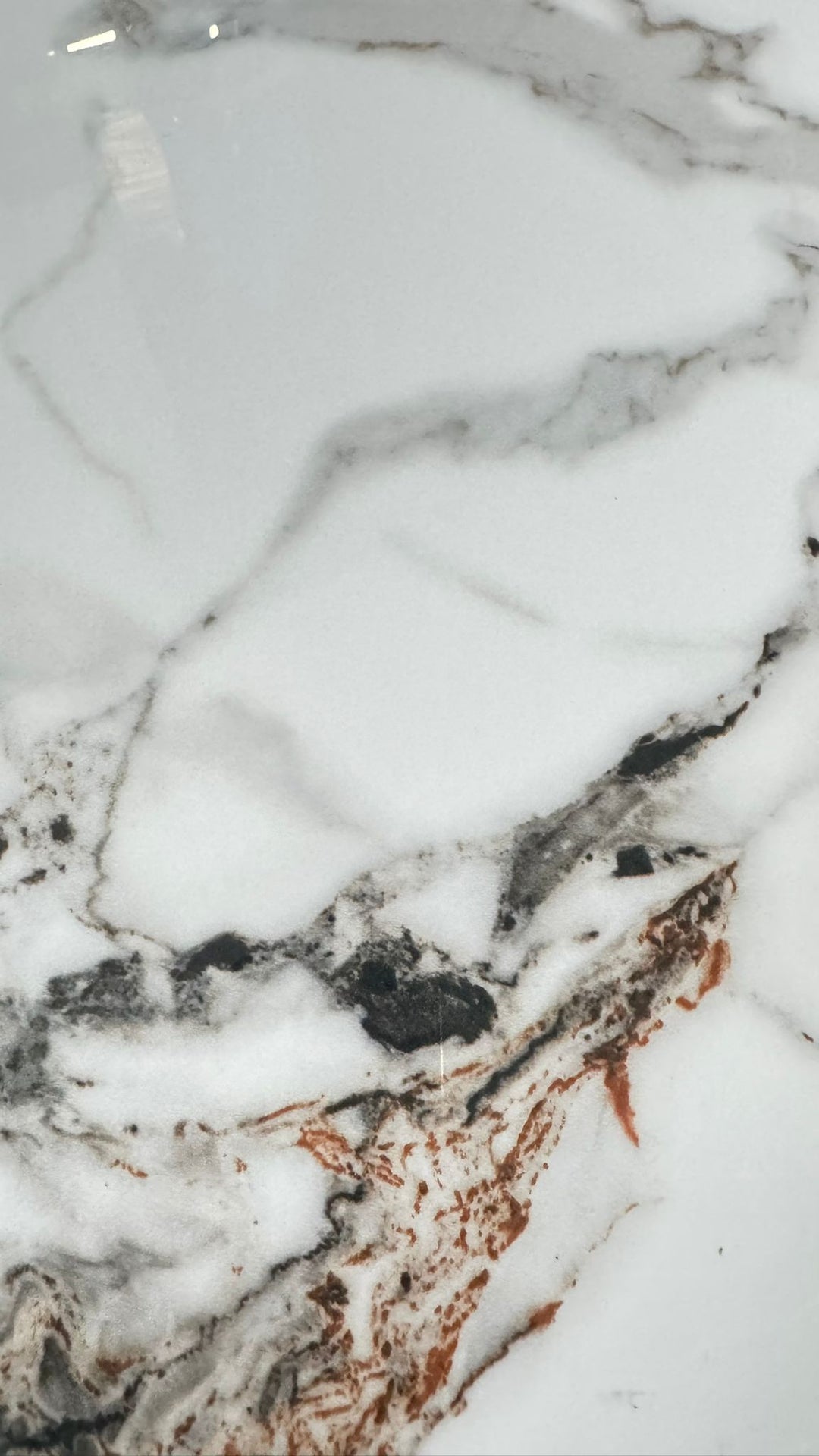 White marble surface with grey and brown veining, ideal for dining or coffee tables.