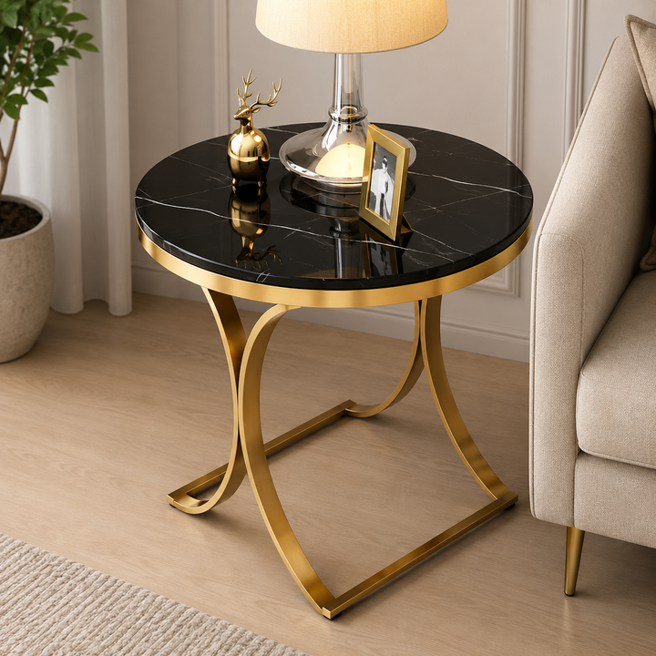 Black marble top side table with gold metal legs, styled with lamp and decor in modern living room