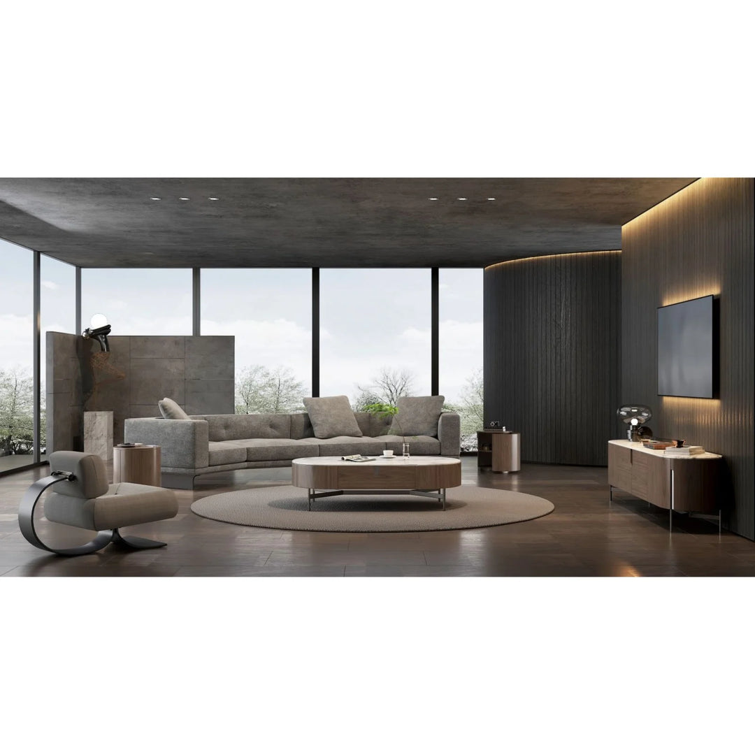 Modern living room with gray sectional sofa, TV unit, coffee table, and large windows