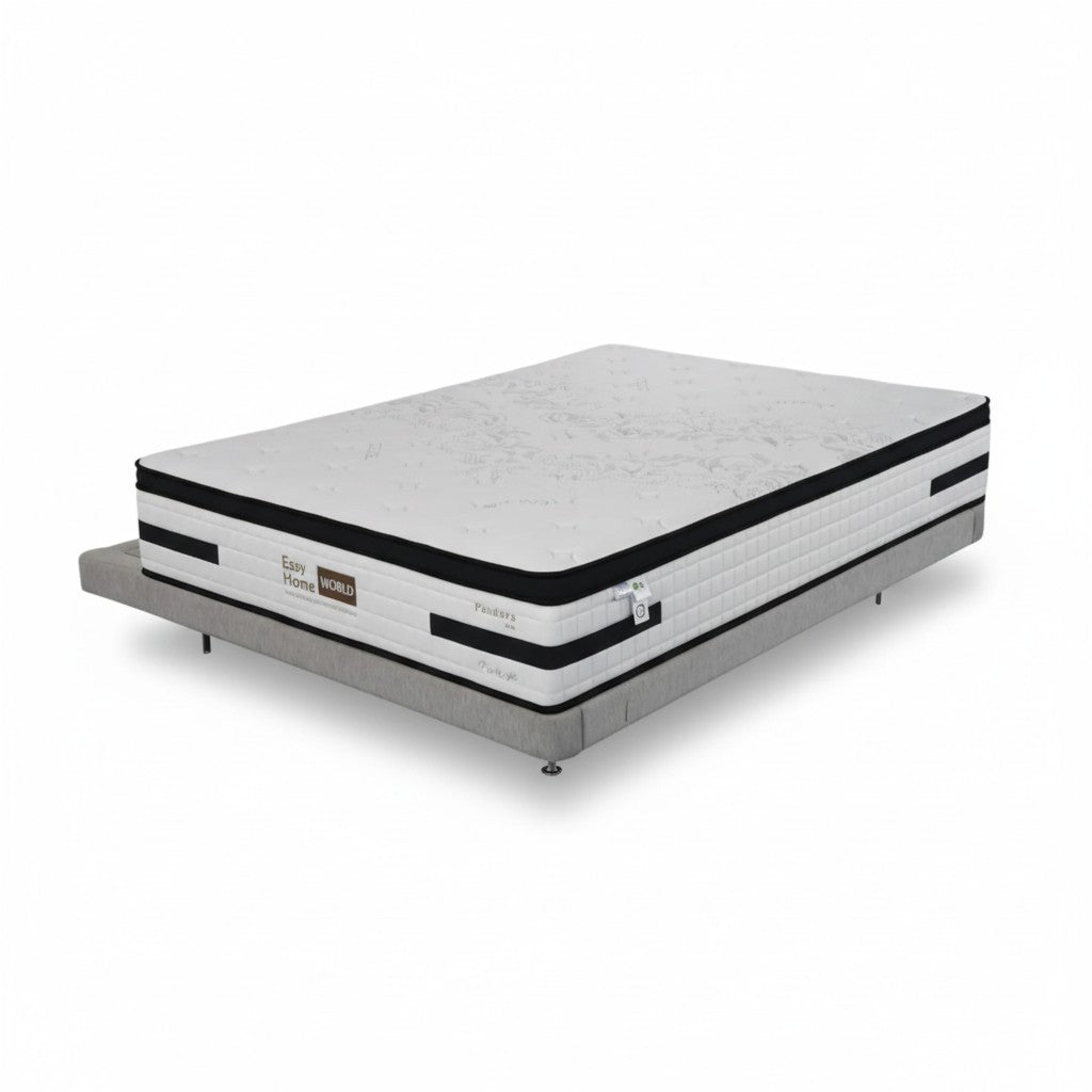 Modern queen size mattress with white and black detailing on a grey upholstered bed base