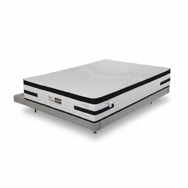 Modern queen size mattress with white and black detailing on a grey upholstered bed base