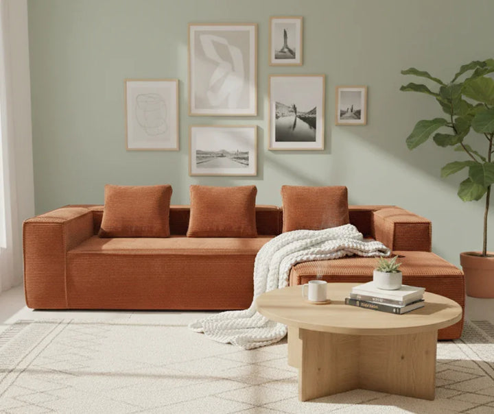 Modern living room with terracotta sectional sofa, wooden coffee table, neutral decor