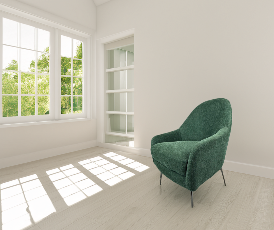 Modern green upholstered accent chair in a bright living room with large windows