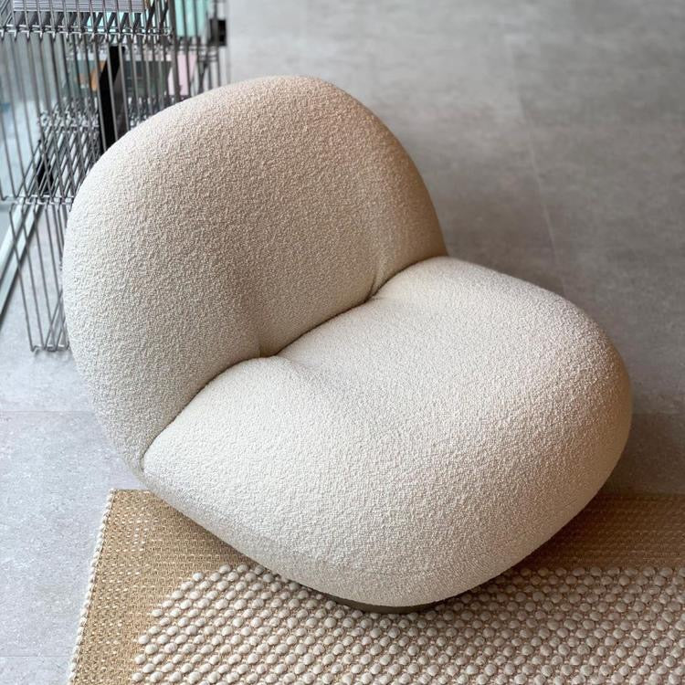 Cream bouclé armchair with rounded design, modern lounge seating for living room or bedroom