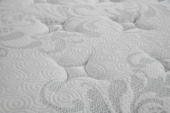 Close-up of white mattress surface with quilted, textured pattern for home bedroom