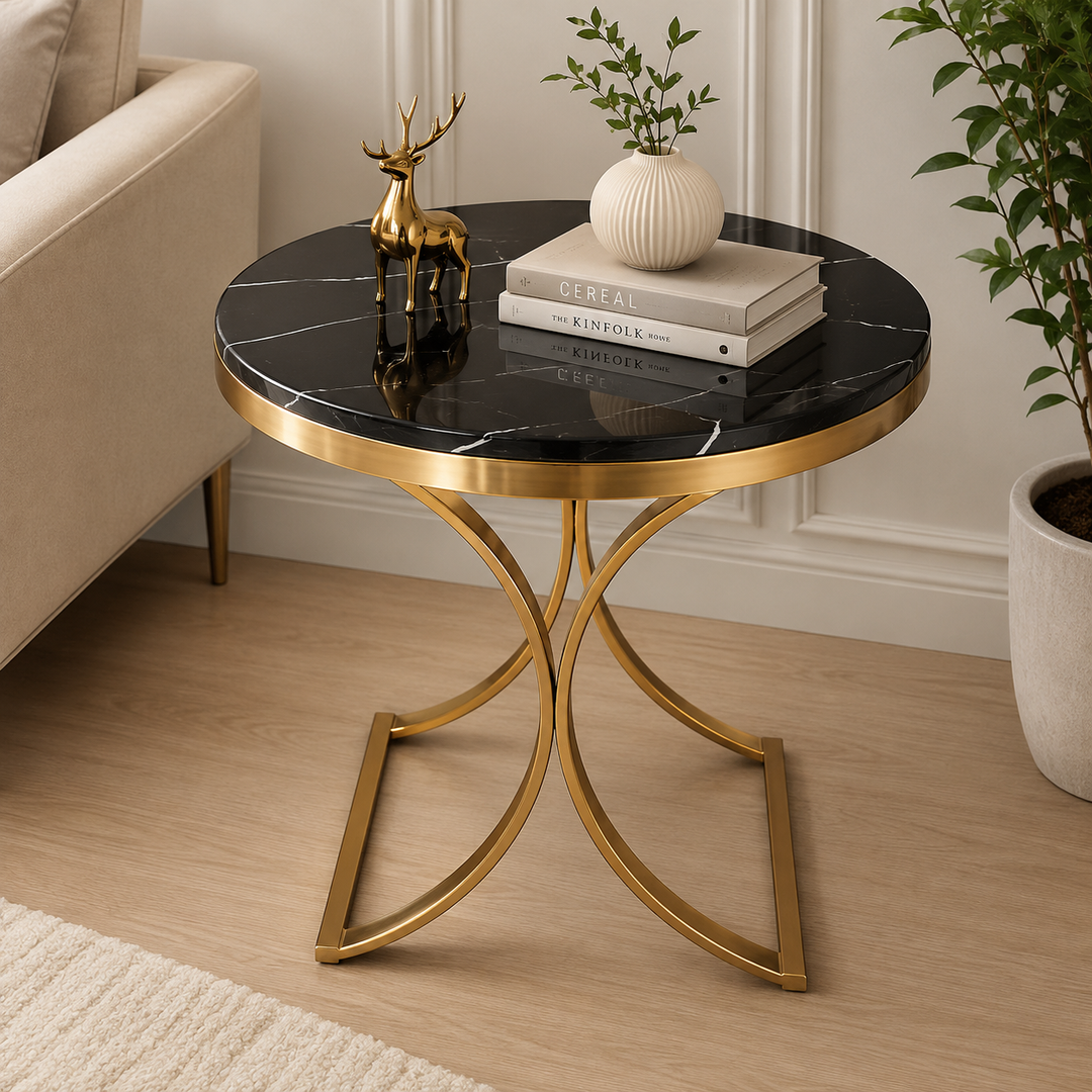 Black marble side table with gold metal base, styled with books and decor in modern living room