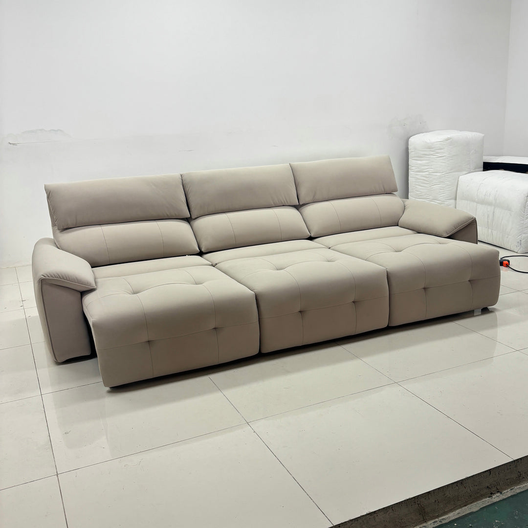 Modern beige sectional sofa with tufted cushions in minimal living room setting