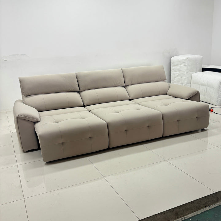 Modern beige sectional sofa with tufted cushions in minimal living room setting