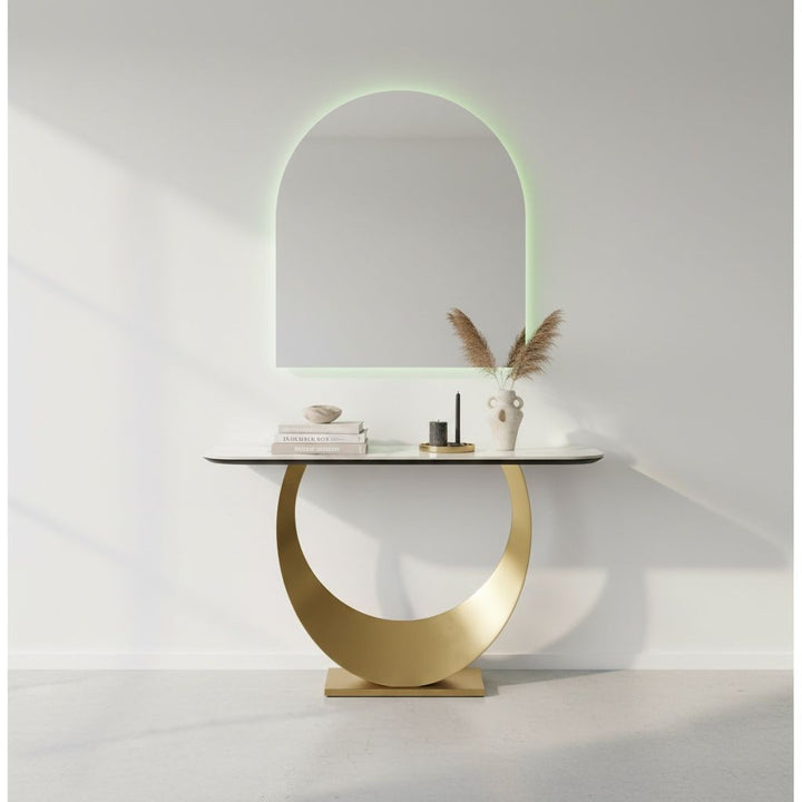 Modern gold and marble console table with decorative vase and arch LED wall mirror