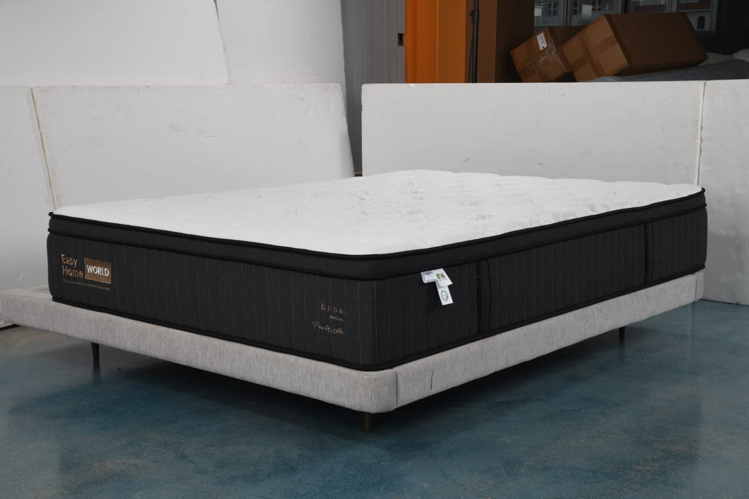 Modern bed with thick black and white mattress on upholstered platform base