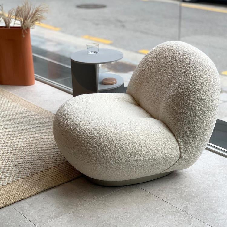 Cream bouclé armchair with modern design, perfect for living room or lounge space