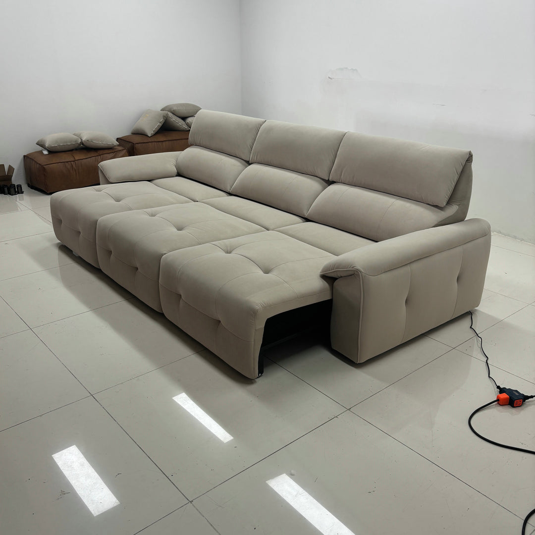 Modern beige sectional sofa with reclining seats in a minimalist living room setting