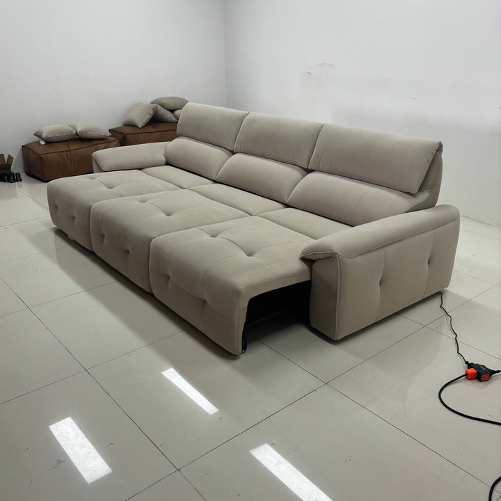 Modern beige sectional sofa with reclining seats in a minimalist living room setting