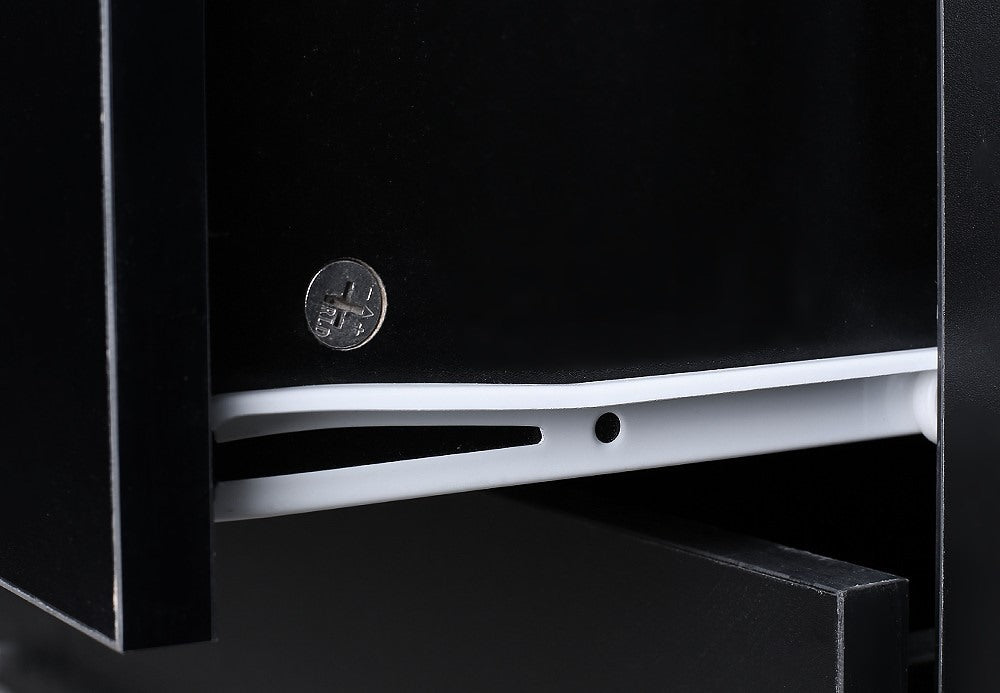 Close-up of black wooden drawer with white plastic rail and metal screw, home furniture detail