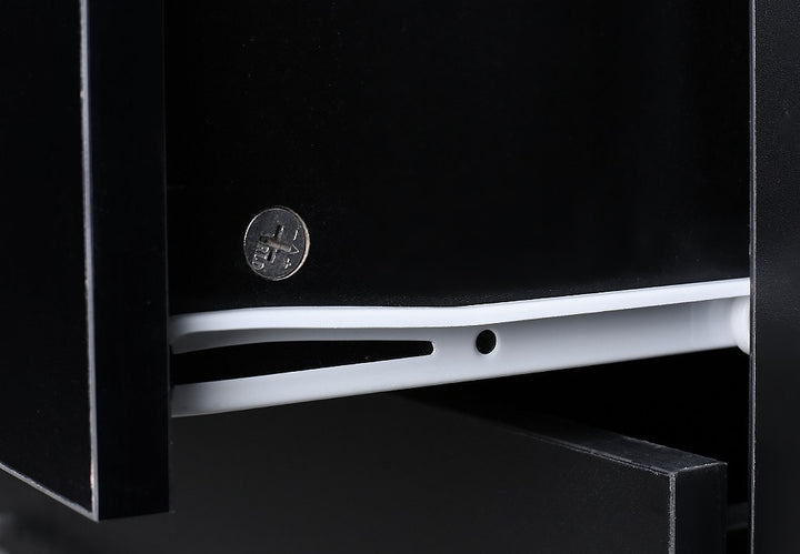 Close-up of black wooden drawer with white plastic rail and metal screw, home furniture detail