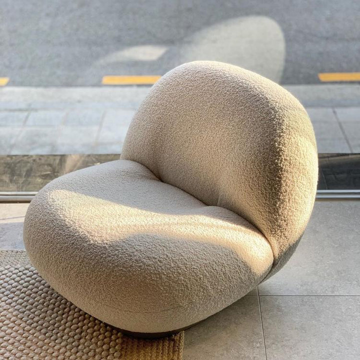 Beige bouclé armchair for modern living room, cozy textured upholstery, stylish lounge seating