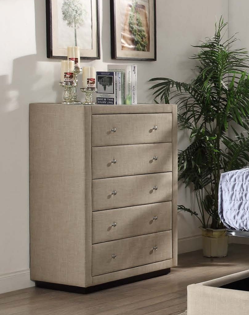 Beige upholstered chest of drawers in modern bedroom with indoor plant and wall art