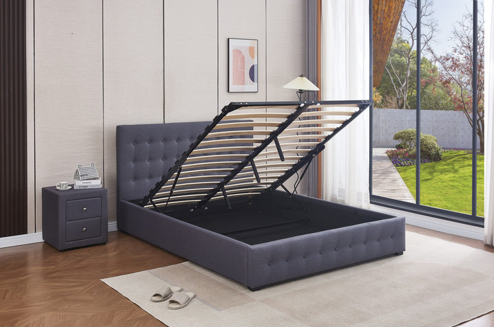 Modern gas lift storage bed in fabric with lifted slats, in a bright bedroom by large windows