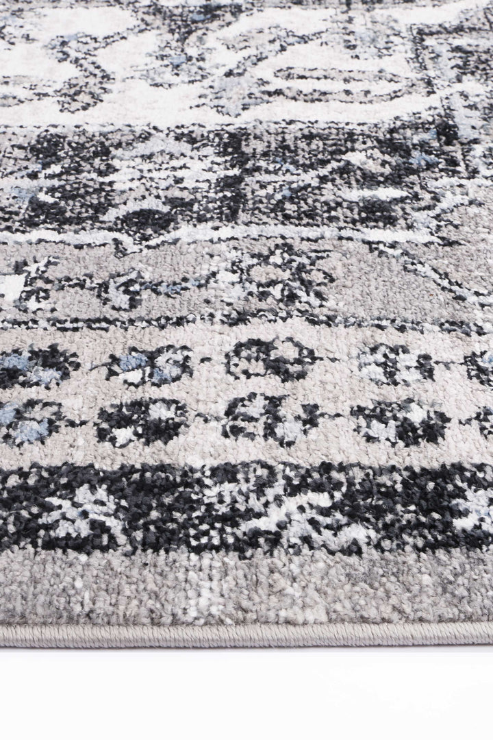 Close-up of grey and black patterned area rug with soft textured pile