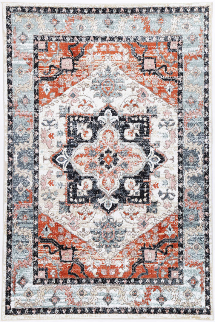 Vintage style area rug with geometric pattern in red, blue, and cream tones
