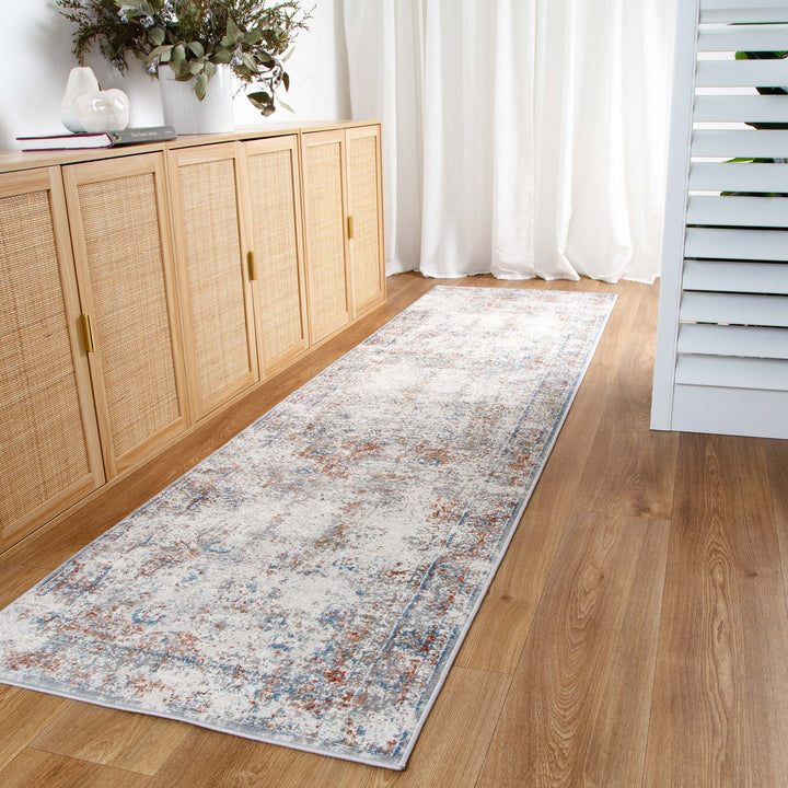Modern distressed hallway runner rug on wood floor beside rattan cabinets and white curtains
