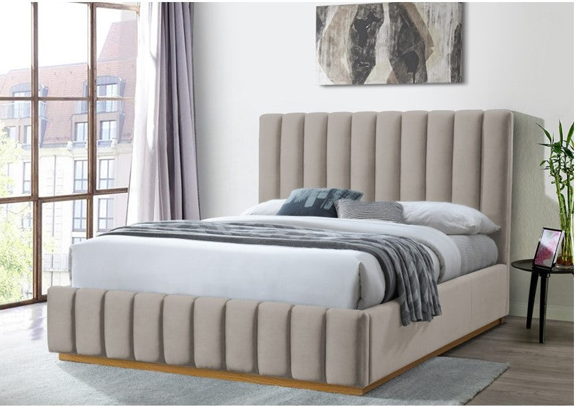 Modern platinum upholstered bed with tall vertical panel headboard in a bright bedroom