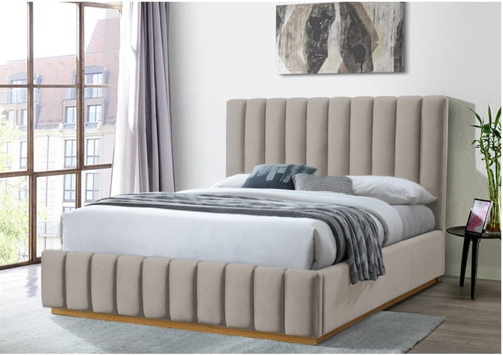 Modern platinum upholstered bed with tall vertical panel headboard in a bright bedroom