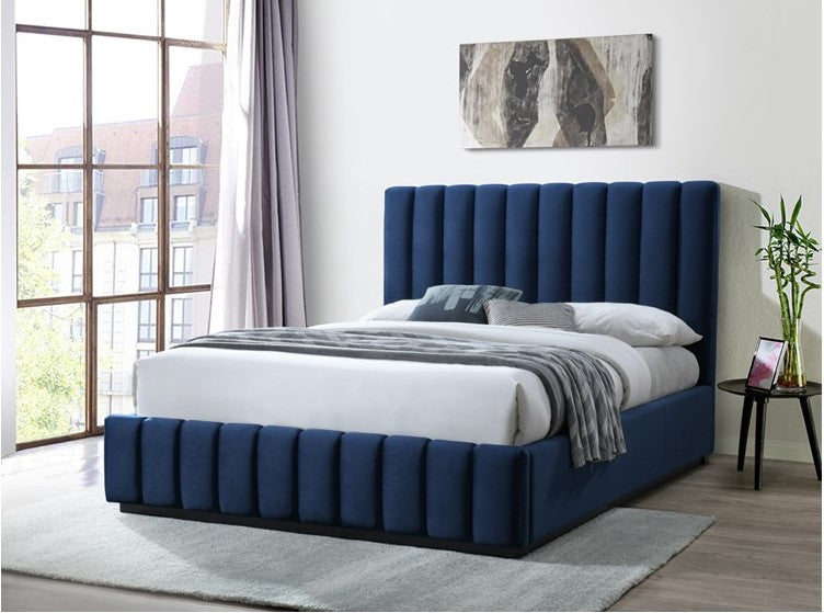 Modern upholstered blue bed with vertical panel headboard in a bright bedroom