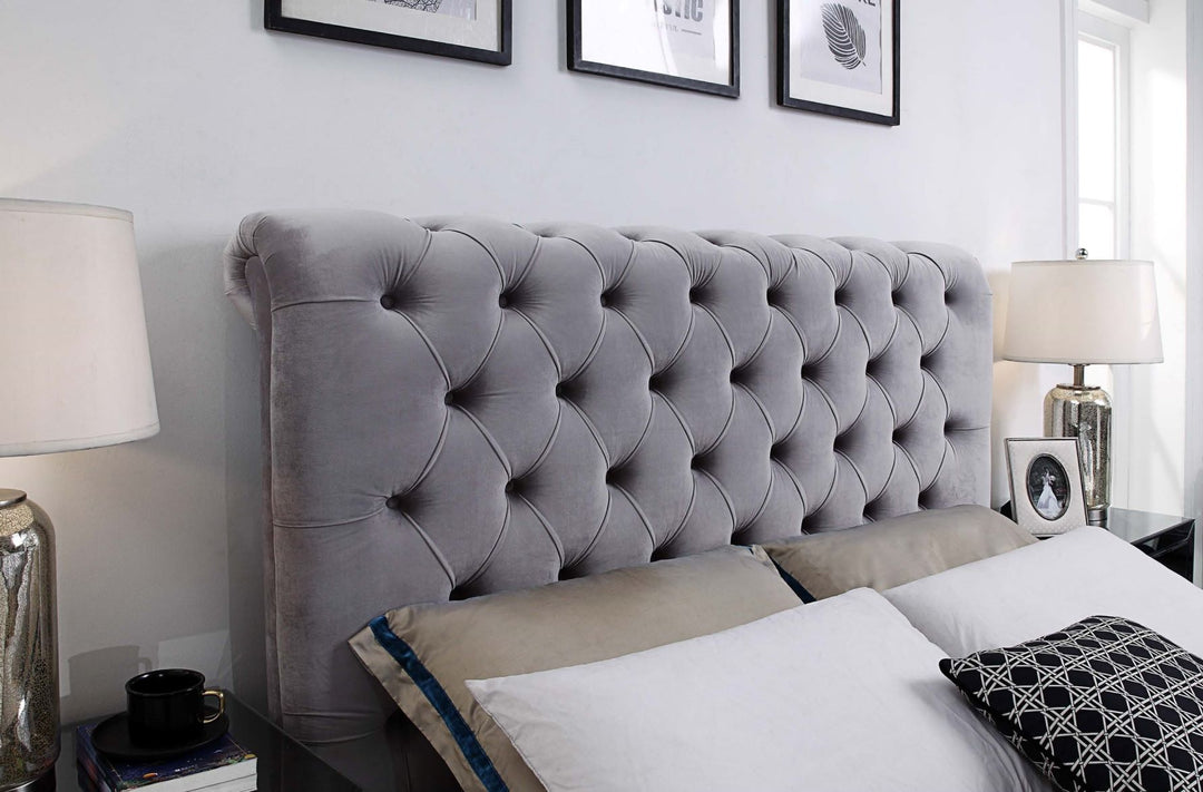 Grey tufted velvet bed headboard with pillows in a modern bedroom setting