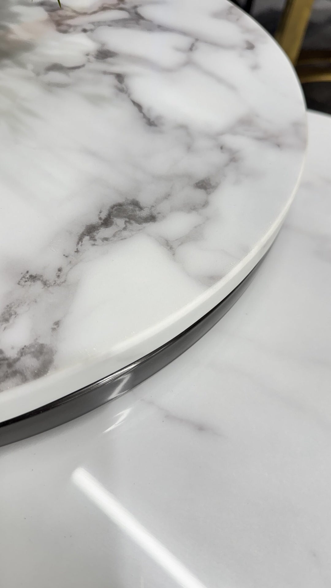 White marble dining table with grey veining and chrome edge detail