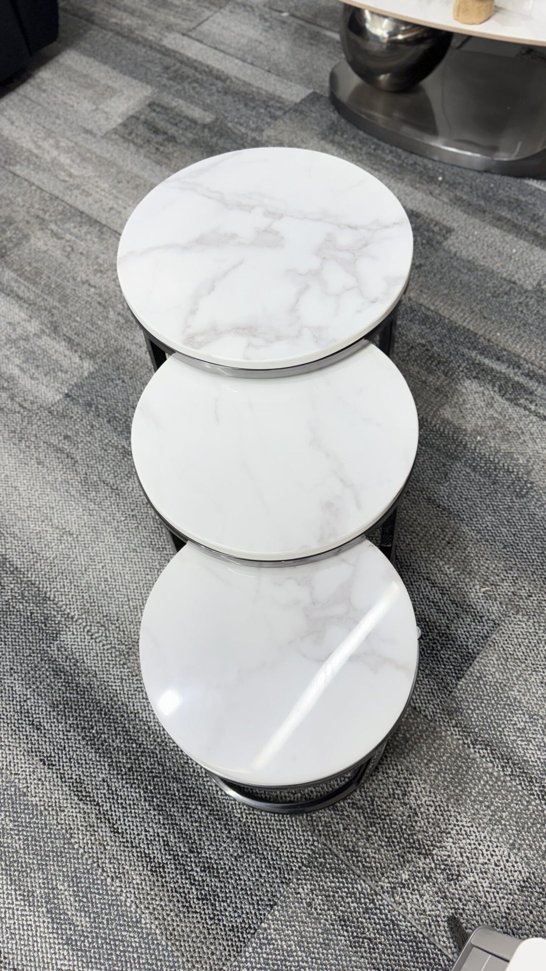 Set of three round marble-top side tables with chrome trim, modern living room furniture