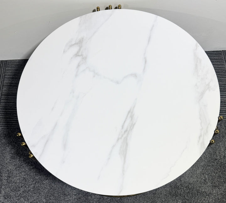 Round white marble coffee table on gray carpeted floor