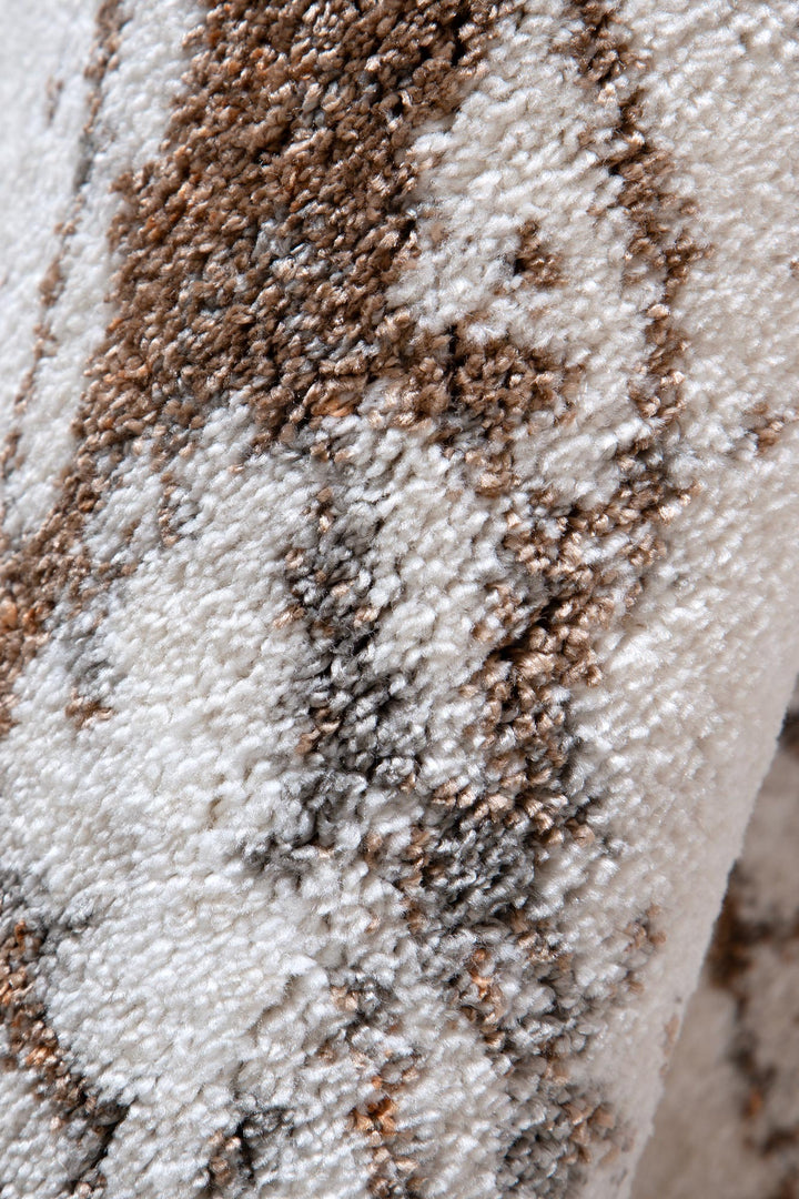 Close-up of plush beige and brown patterned carpet or rug texture