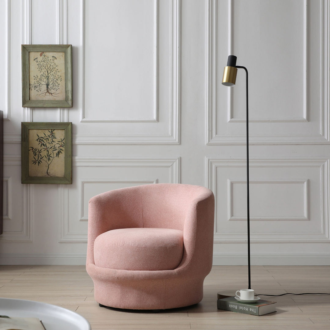 Modern pink accent chair with curved backrest beside black floor lamp in elegant living room