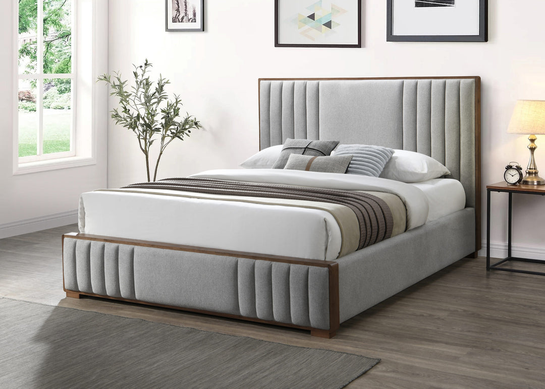 Modern grey upholstered queen bed with vertical panel headboard in a bright bedroom