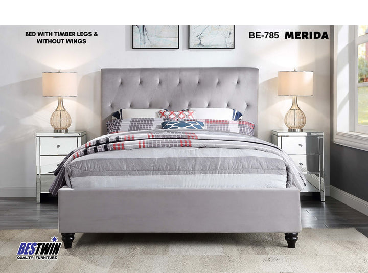 Light grey upholstered bed with timber legs, tufted headboard, and modern bedroom decor