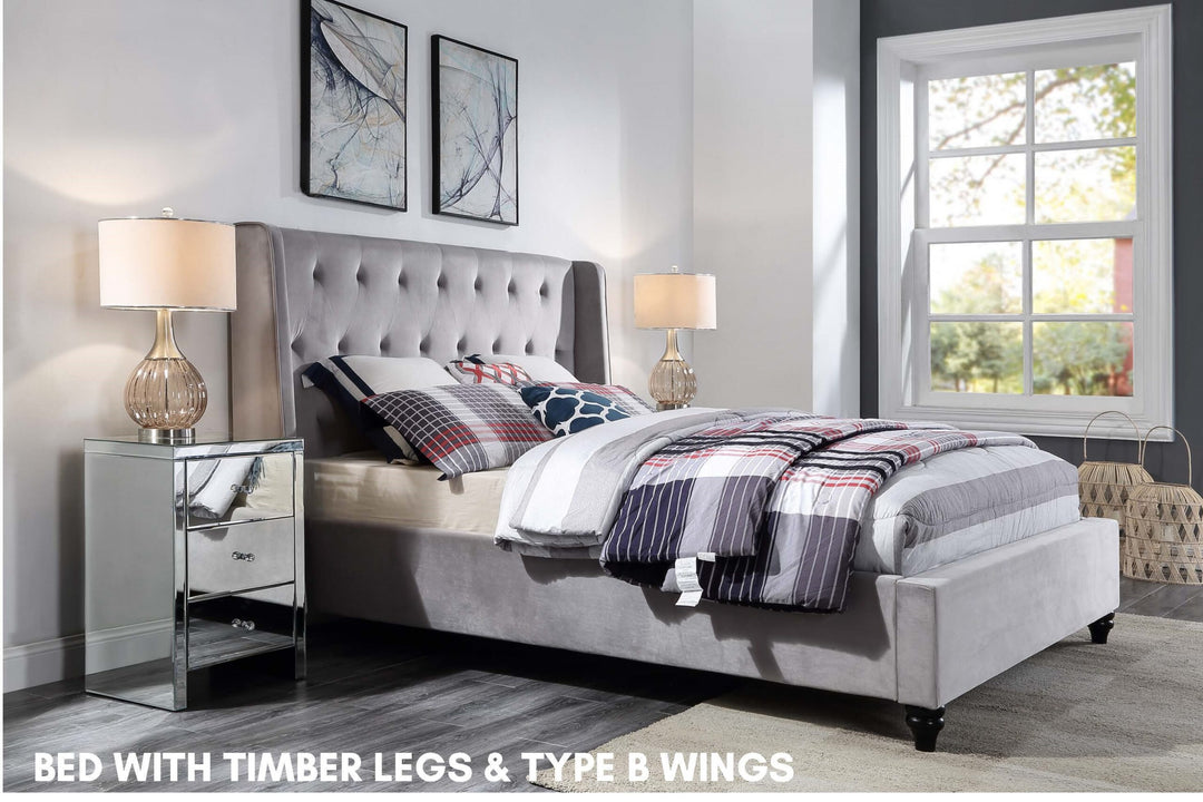Light grey upholstered bed with timber legs and wingback headboard in modern bedroom