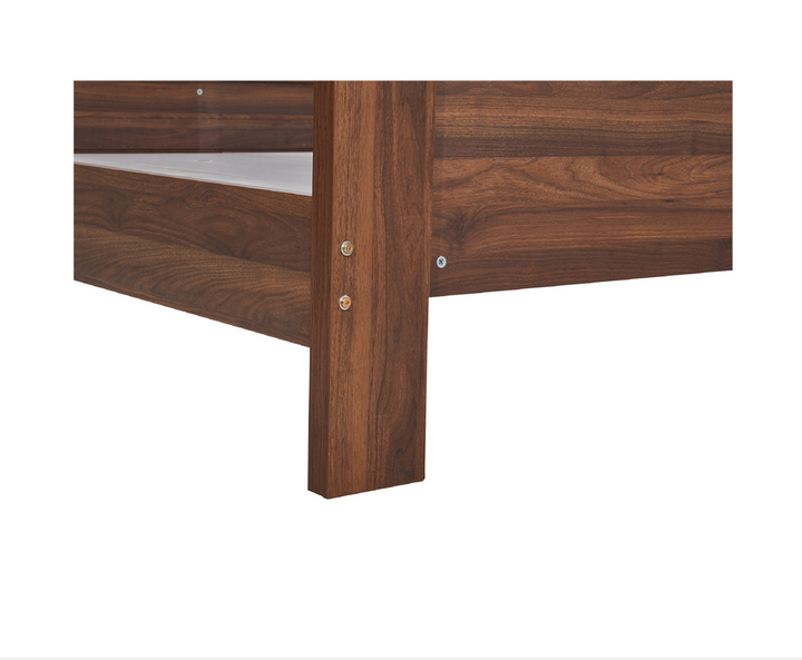 Close-up of modern wooden bed frame corner with natural wood grain finish