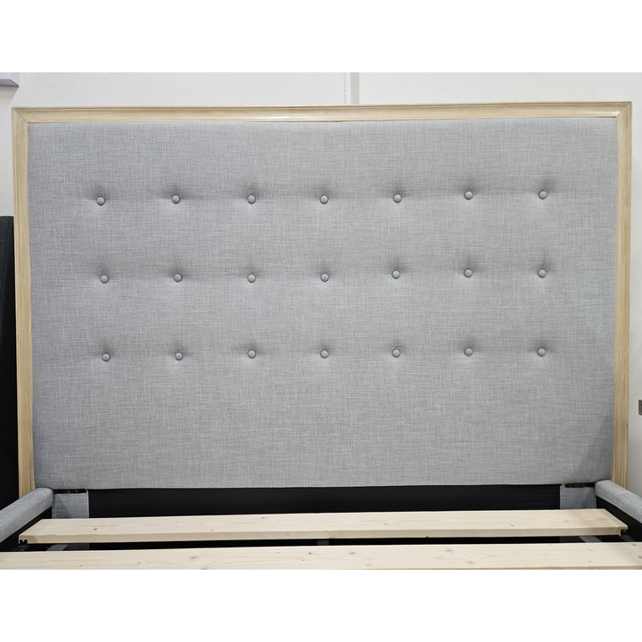 Modern upholstered bed frame with light grey tufted headboard and wooden trim