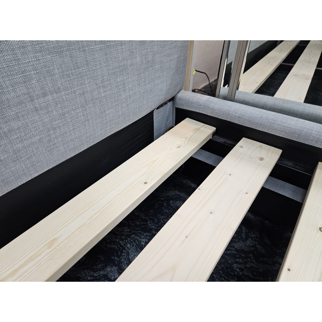 Close-up of wooden bed slats on modern upholstered bed frame