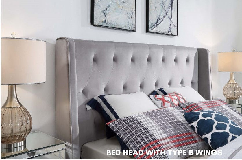 Light grey tufted bed headboard with side wings in modern bedroom, plaid bedding, table lamps