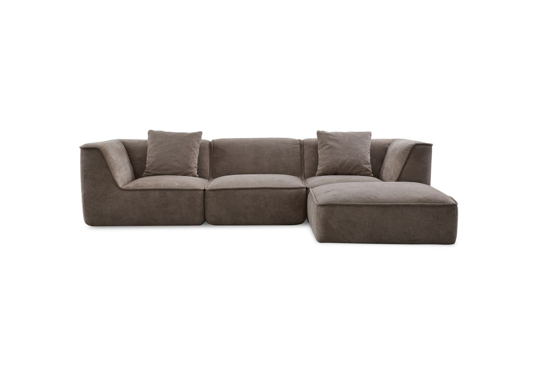 Modern brown sectional sofa with chaise lounge and two throw pillows, isolated on white