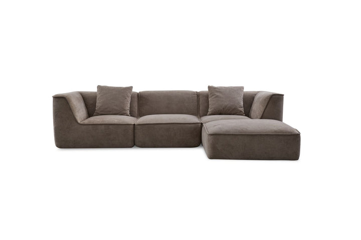 Modern brown sectional sofa with chaise lounge and two throw pillows, isolated on white