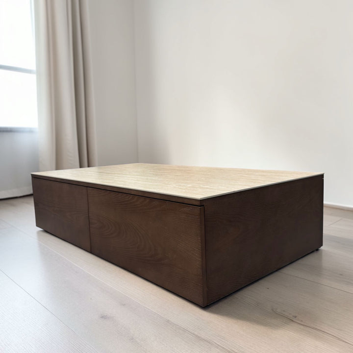 Modern rectangular wooden coffee table with light top in a minimalist living room