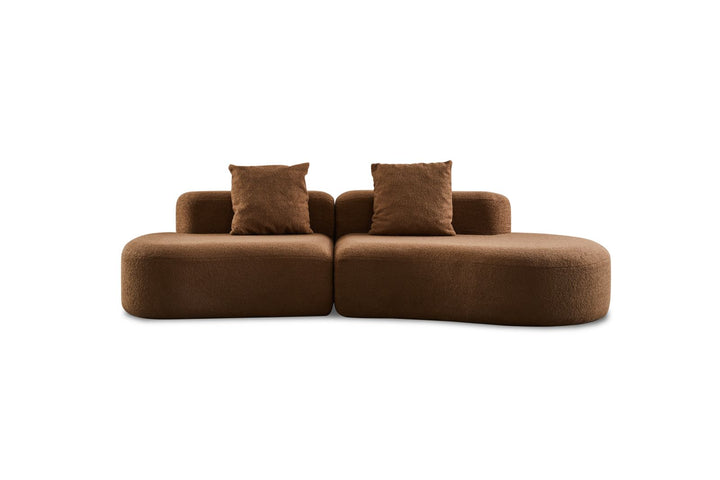 Modern brown sectional sofa with two matching throw pillows, curved design, isolated on white